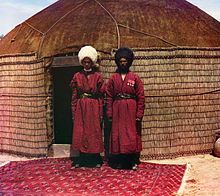 Two Turkmen men on a Turkmen rug in front of a yurt. (1905–1915)